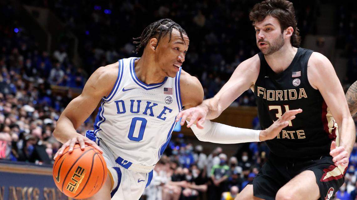 Duke’s Wendell Moore Jr. (0) drives by Florida State’s Wyatt Wilkes (31) during the first half of Duke’s game against Florida State at Cameron Indoor Stadium in Durham, N.C., Sat. Feb. 19, 2022.