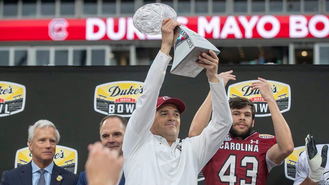 South Carolina coach Shane Beamer hoists the Duke’s Mayo Bowl trophy following the Gamecocks’ 38-21 victory over North Carolina on Thursday, December 30, 2021 at Bank of America Stadium in Charlotte, N.C.