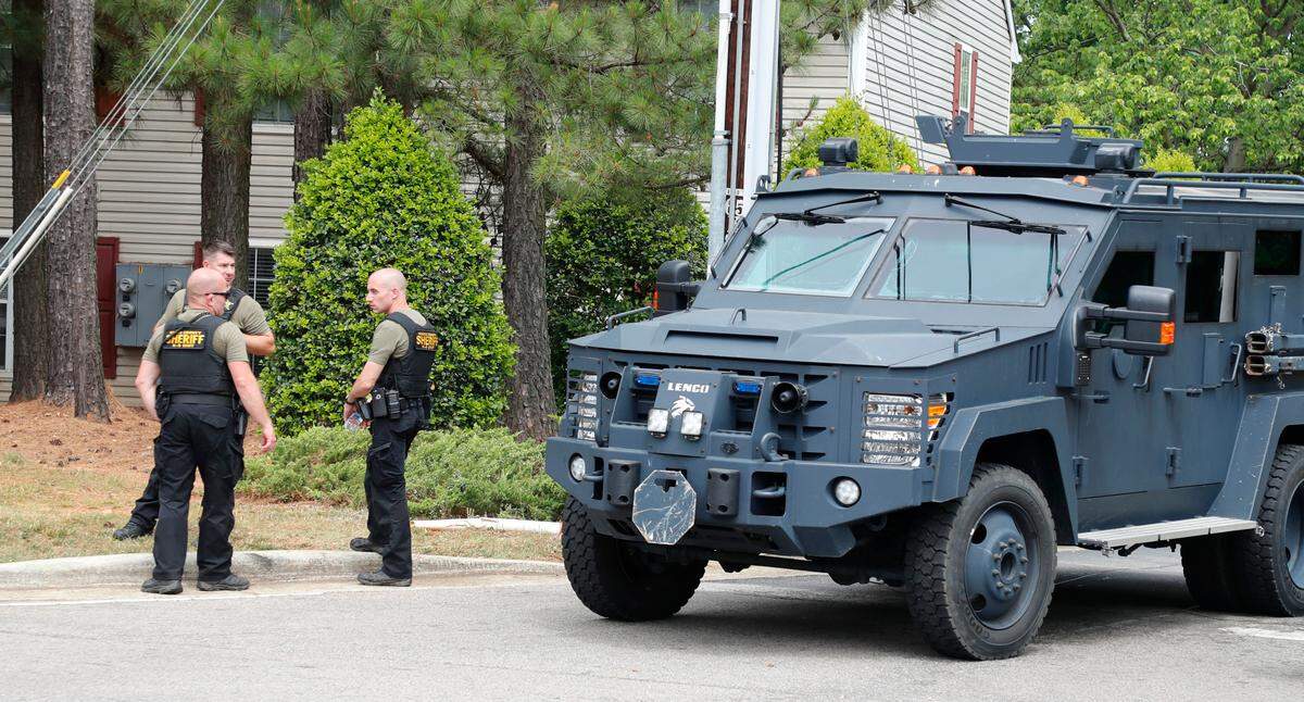 Vehicles exit River Birch Apartments on Old Wake Forest Road in Raleigh, N.C., Wednesday, June 2, 2021, after a Wake County sheriff’s deputy was shot during an eviction process, said Wake County Sheriff’s Office spokesperson Eric Curry.