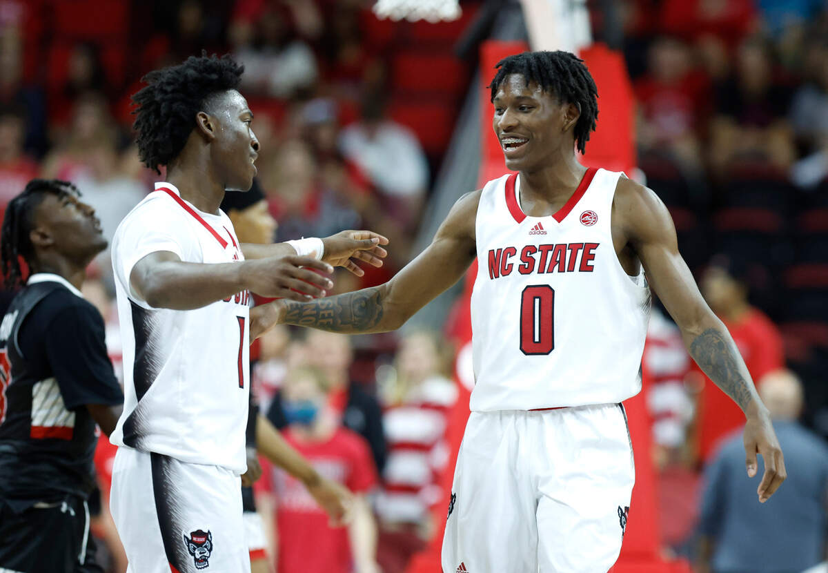 N.C. State’s Jarkel Joiner (1) and Terquavion Smith (0) congratulate each other during the second half of N.C. State’s 99-50 victory over Austin Peay at PNC Arena in Raleigh, N.C., Monday, Nov. 7, 2022.