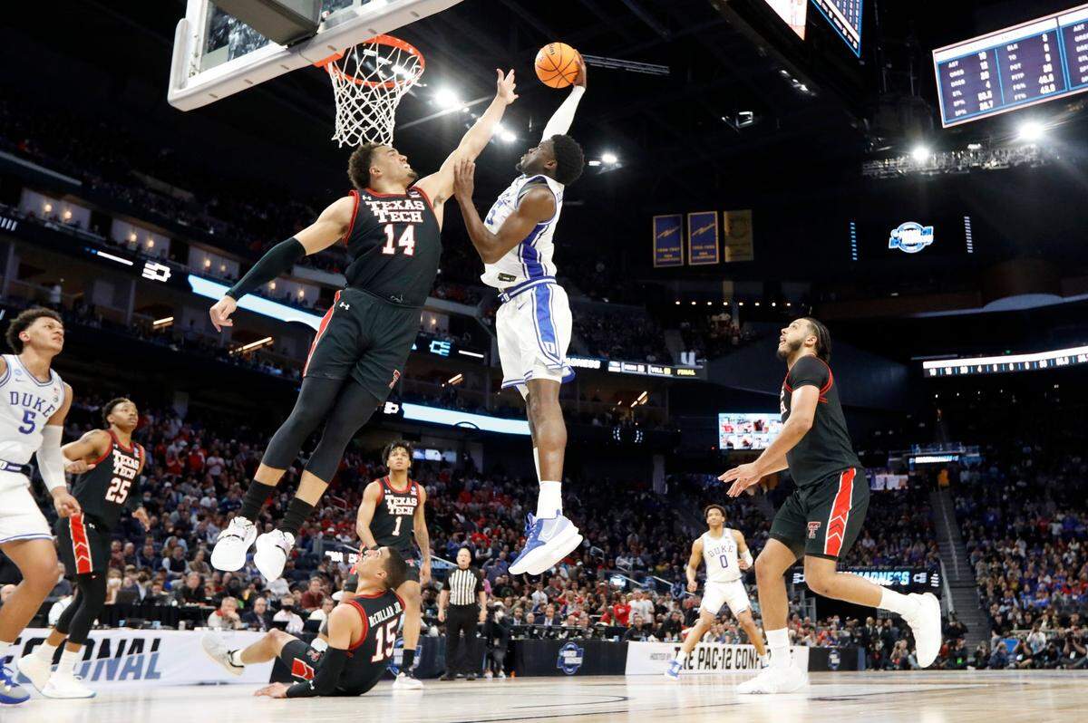 Dukes Mark Williams (15) slams in two over Texas Tech’s Marcus Santos-Silva (14) during Dukes 78-73 victory over Texas Tech in the Sweet 16 round of the NCAA Tournament at the Chase Center in San Francisco, Calif., Thursday, March 24, 2022.