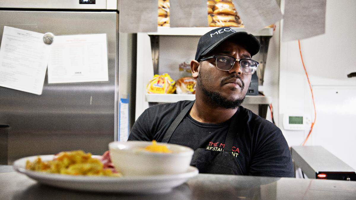 Chef Malcolm Fennell checks breakfast tickets Tuesday morning, May 24, 2022, on the first day The Mecca has been back open for business.