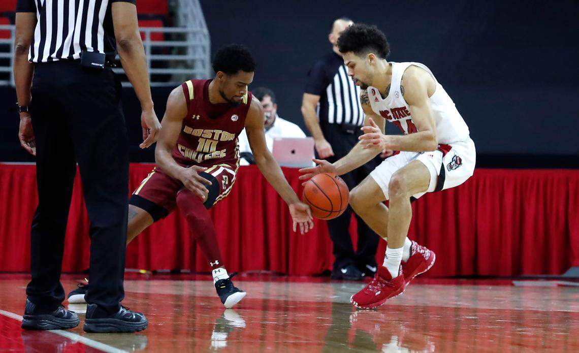 N.C. State’s Devon Daniels (24) knocks the ball from Boston College’s Wynston Tabbs (10) with under 20 second left in the game during N.C. State’s 79-76 victory over Boston College at PNC Arena in Raleigh, N.C., Wednesday, December 30, 2020.