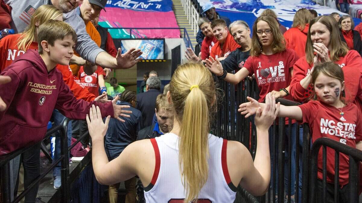 North Carolina State’s Elissa Cunane high-fives fans after the team’s win over Florida State during an NCAA college basketball game in the Atlantic Coast Conference women’s tournament in Greensboro, N.C., Friday, March 8, 2019.