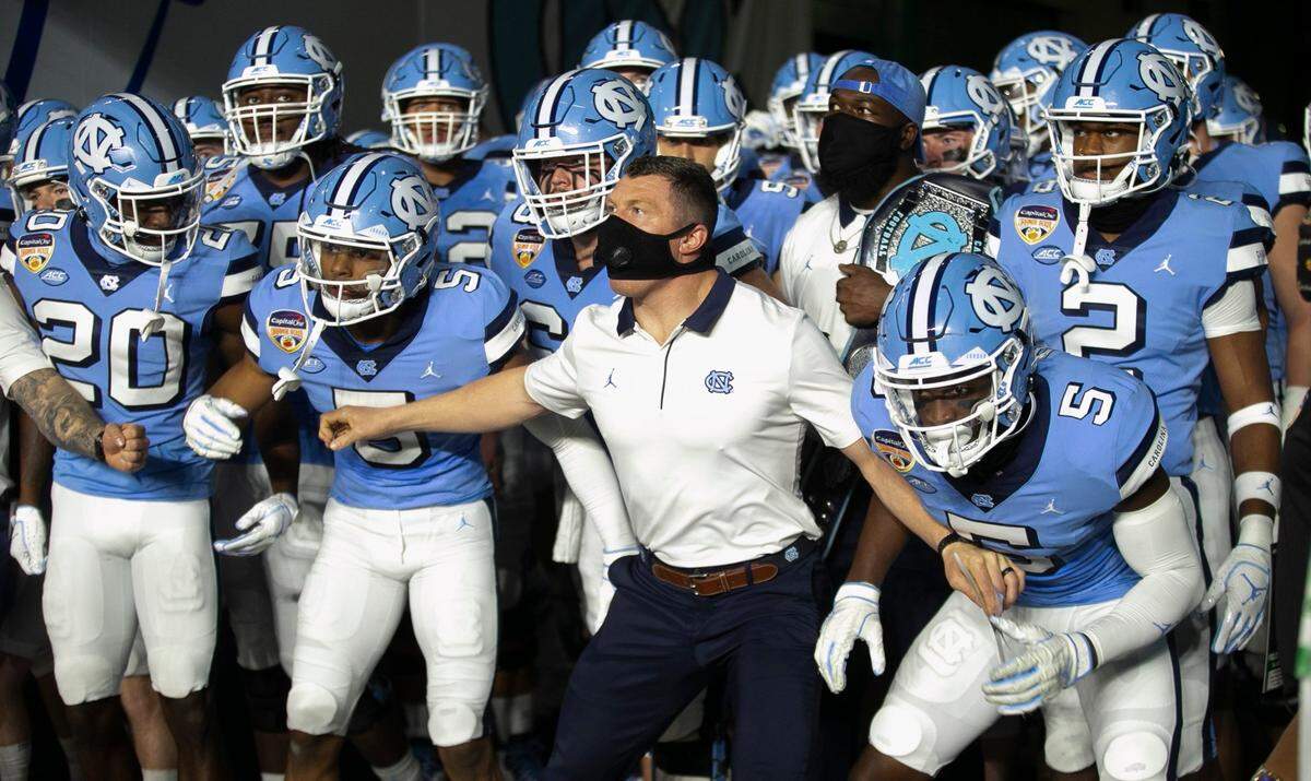 North Carolina strength and conditioning coach Brian Hess holds his players back as they wait for the signal to enter Hard Rock Stadium for their game against Texas A&M on Saturday, January 2, 2021in Miami Gardens, Florida. 