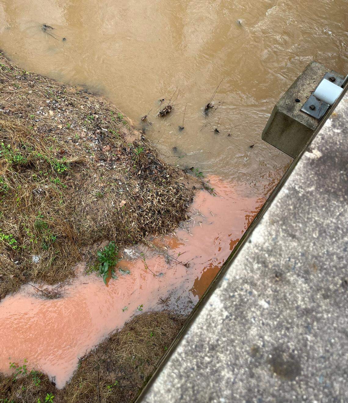 Water from a construction site off Olive Branch Road flows into Lick Creek on March 2, 2023.
