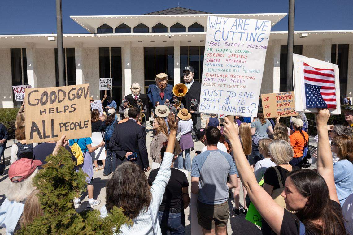 Protesters opposed to cuts and actions by DOGE and Elon Musk rally outside of the N.C. Legislative Building on Wednesday, March 12, 2025.