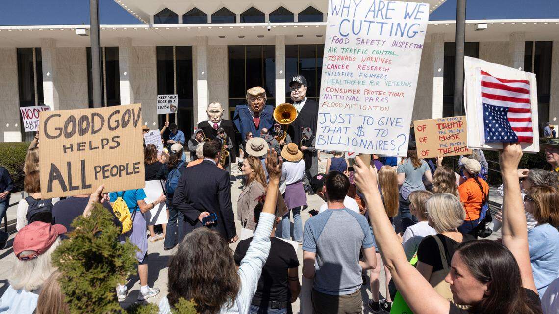 Protesters opposed to cuts and actions by DOGE and Elon Musk rally outside of the N.C. Legislature, Wednesday, March 12, 2025.