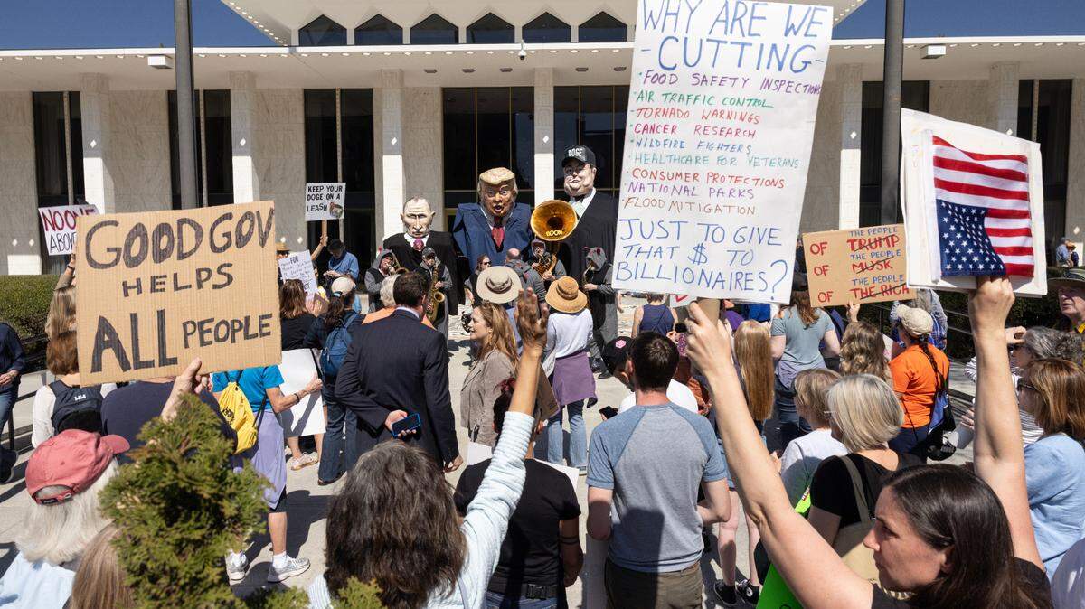 Protesters opposed to cuts and actions by DOGE and Elon Musk rally outside of the N.C. Legislature, Wednesday, March 12, 2025.