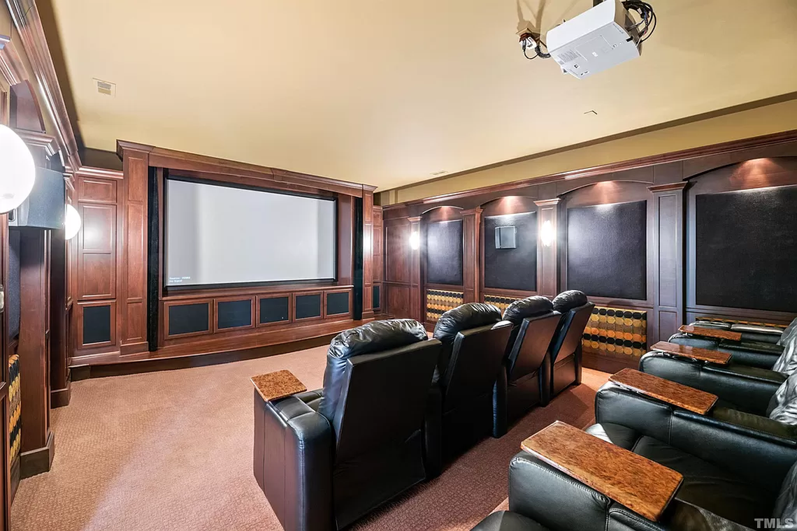 A theater with a screen 130 inches wide and surround sound connected to vibrating seats makes for an immersive movie-watching or gaming experience.
