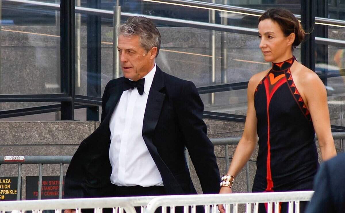 British actor Hugh Grant and Swedish producer Anna Elisabet Eberstein arrive at Madison Square Garden, the reported venue for the wedding celebrations of pop singer Taylor Swift and pro-athlete Travis Kelce, in New York City on July 3, 2026. Swift and Kelce's official wedding plans are tightly under wraps, but New York is bracing to host the celebrity marriage of the year this week at Madison Square Garden. The wedding will reportedly take place Friday with a star-studded guest list of around 1,000, including models Gigi Hadid and Cara Delevingne, singer Selena Gomez, and actress Zoe Kravitz -- all known to be close Swift pals -- and Kelce's Kansas City Chiefs teammates. (Photo by kena betancur / AFP via Getty Images)