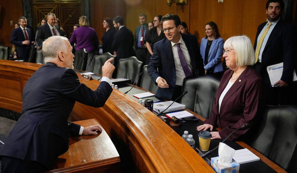 Sen. Thom Tillis, a North Carolina Republican, speaks to Sen. Brian Schatz, a Hawaii Democrat who chairs the Senate Appropriations Committee, and Sen. Patty Murray, a Washington Democrat, before the start of the Senate Appropriations Committee hearing to examine disaster funding needs on Wednesday, Nov. 20, 2024.