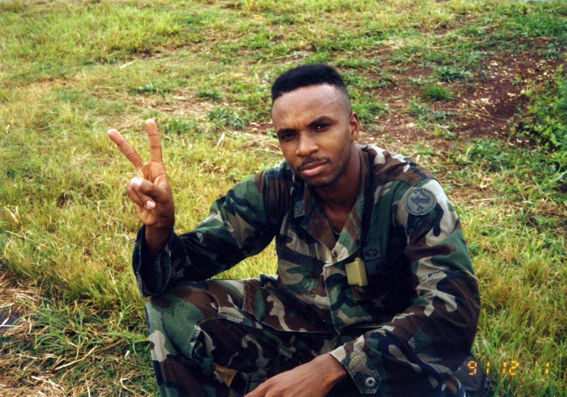 Ricky Moore flashes a peace sign while serving in the Army in 1991.