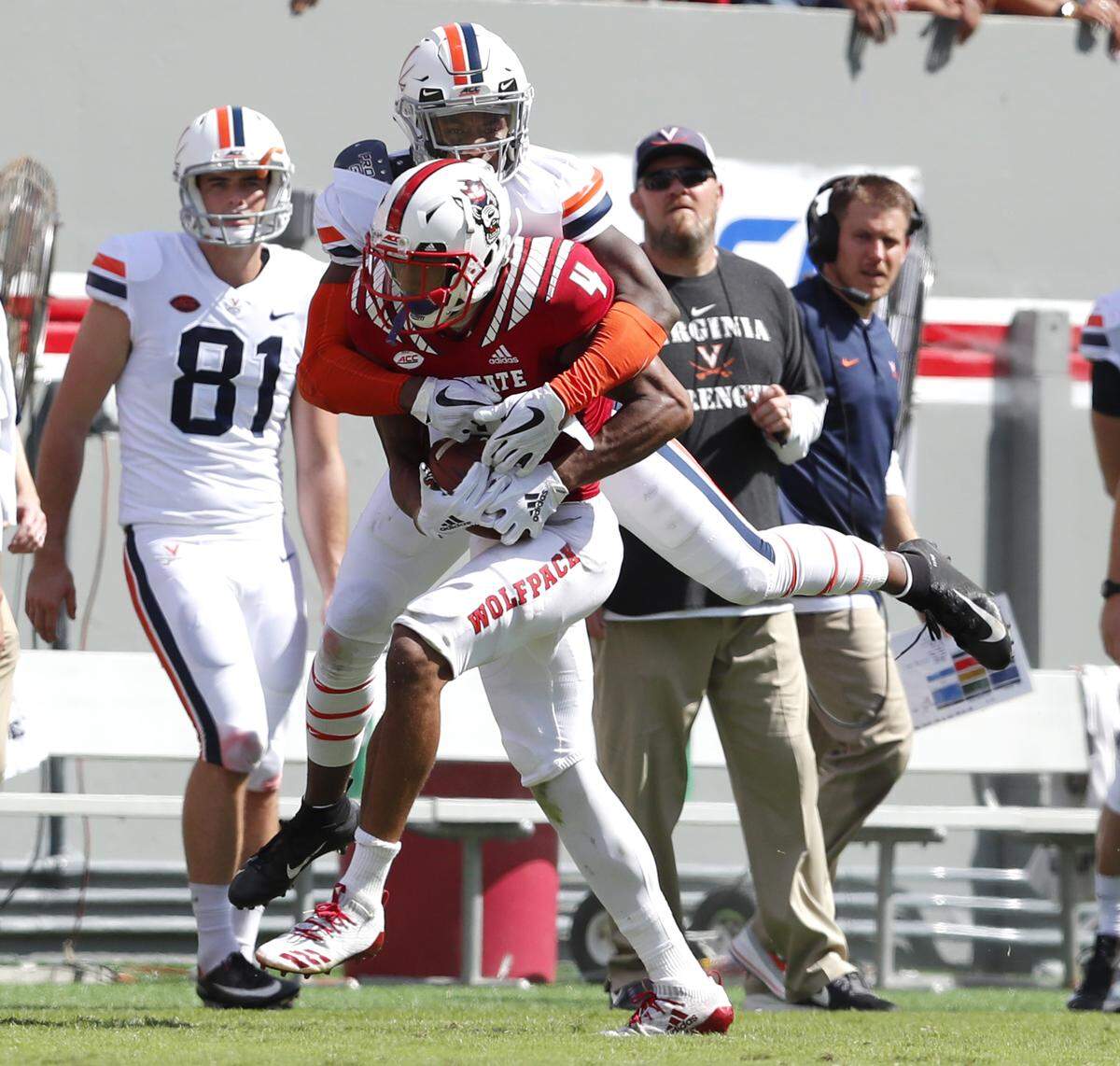 N.C. State cornerback Nick McCloud (4) intercepts the ball intended for Virginia wide receiver Hasise Dubois (8) during the Wolfpack’s victory at Carter-Finley Stadium Saturday, Sept. 29, 2018.