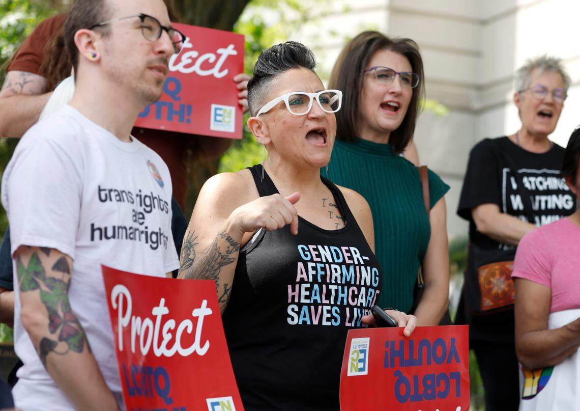 Gwenn Mangine of Cary, center, and others participate in a rally opposing HB 574 and SB 631 outside the NC Legislative building Thursday, April 20, 2023. House Bill 574 bans transgender athlete participation in women’s sports in middle, high school and college.