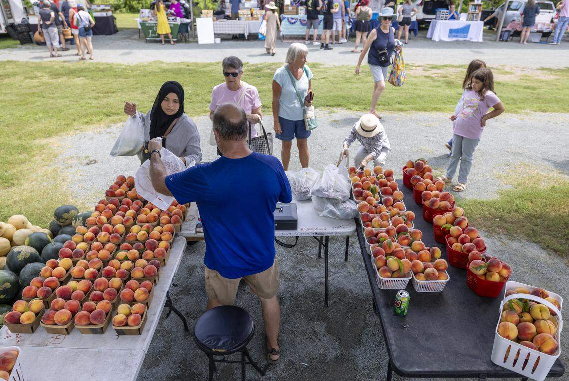 Andy Harman from Kalawi Farm in Eagle Springs, N.C., sells produce during the weekly Farmer’s Market at The Plant on Thursday, July 3, 2025 in Pittsboro, N.C.