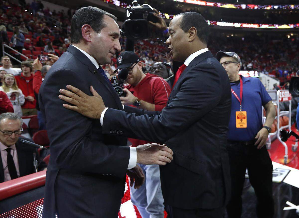 Duke head coach Mike Krzyzewski talks with N.C. State head coach Kevin Keatts before Duke’s game with N.C. State at PNC Arena in Raleigh, N.C., Wednesday, Feb. 19, 2020.