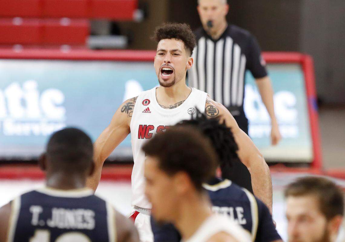 N.C. State’s Devon Daniels (24) celebrates as he heads back to the huddle during the second half of N.C. State’s 95-61 victory over Charleston Southern in the Wolfpack Invitational at Reynolds Coliseum in Raleigh, N.C., Wednesday, Nov. 25, 2020.