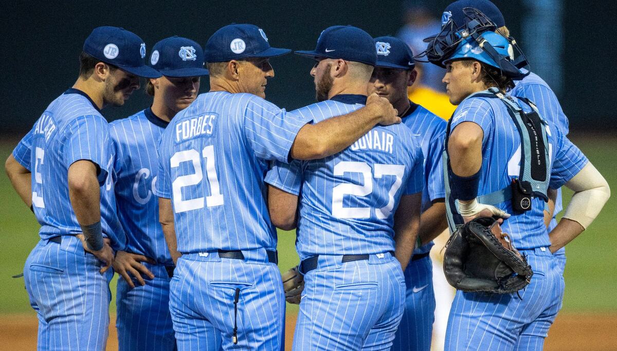 Down 8-2 to LSU in the sixth inning, North Carolina coach Scott Forbes embraces pitcher Connor Bovair (27) before removing him from the mound during the NCAA Regional on Sunday, June 2, 2024 at Boshamer Stadium in Chapel Hill, N.C.