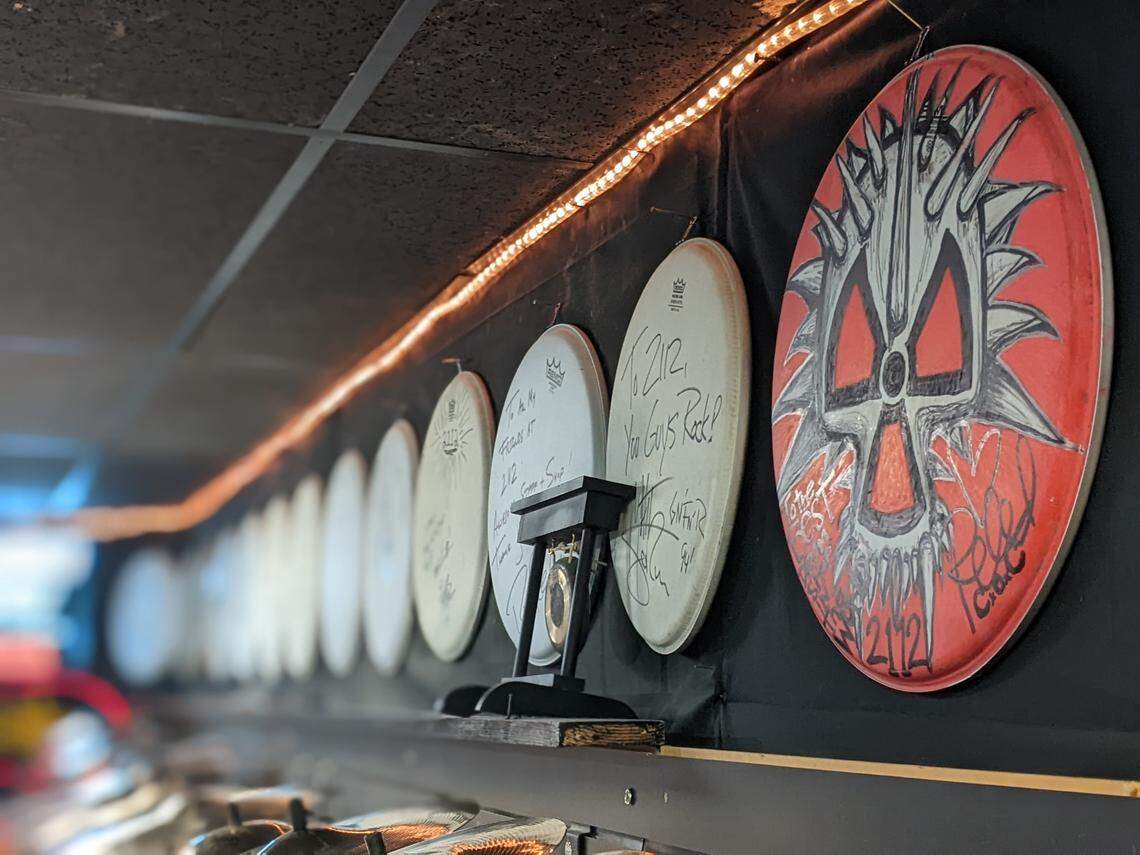 2112 has dozens of signed snare drum batter heads from famous drummers who visited the store. Reed Mullin’s, far right, stands out from the rest. The influential drummer from Raleigh’s Corrosion of Conformity died last year.