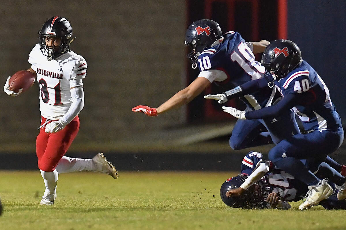 Rolesville wide receiver John Spivey (81) scrambles for yardage against the Apex Friendship defense. The Apex Friendship Patriots and the Rolesville Rams met in  the second round of the  NCHSAA 8A Playoff game in Apex, N.C. on November 14, 2025. Rolesville wins 14-7 in overtime.
