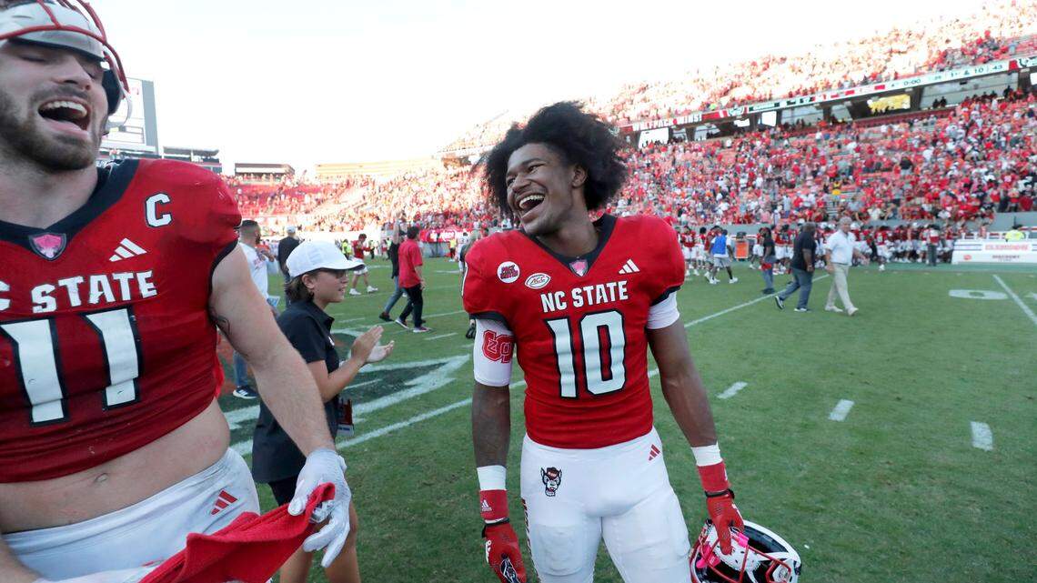 N.C. State wide receiver KC Concepcion (10) laughs with linebacker Payton Wilson (11) after N.C. State’s 24-17 victory over Clemson at Carter-Finley Stadium in Raleigh, N.C., Saturday, Oct. 28, 2023.