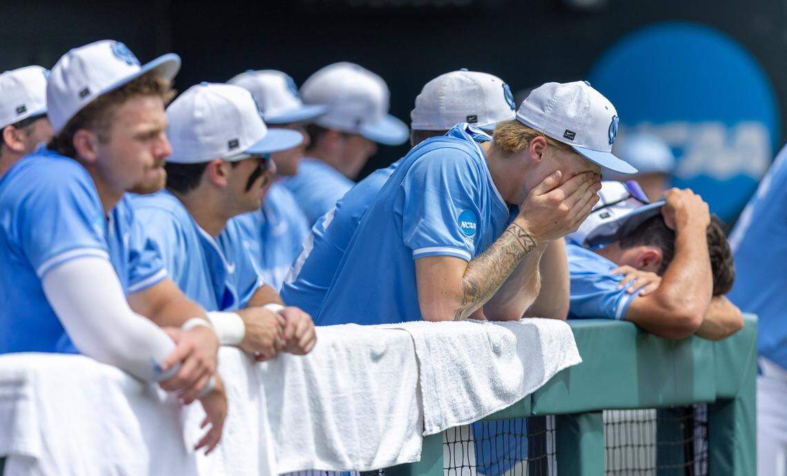 North Carolina pitcher Cameron Padgett (15) covers his face in the Tar Heels’ dugout following their 4-3 loss to Arizona in the NCAA Super Regional final on Sunday, June 8, 2025 at Boshamer Stadium in Chapel Hill, N.C.