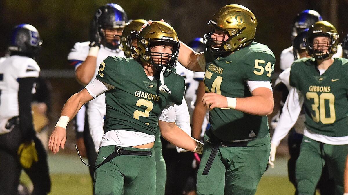Cardinal Gibbons’ Will Mitchell (54) congratulates Brock Biestek (2) after his touchdown during the first quarter. The Cardinal Gibbons Crusaders and the Scotland County Fighting Scots met in the NCHSAA 4A Football Eastern Final in Raleigh, N.C. on December 6, 2019.