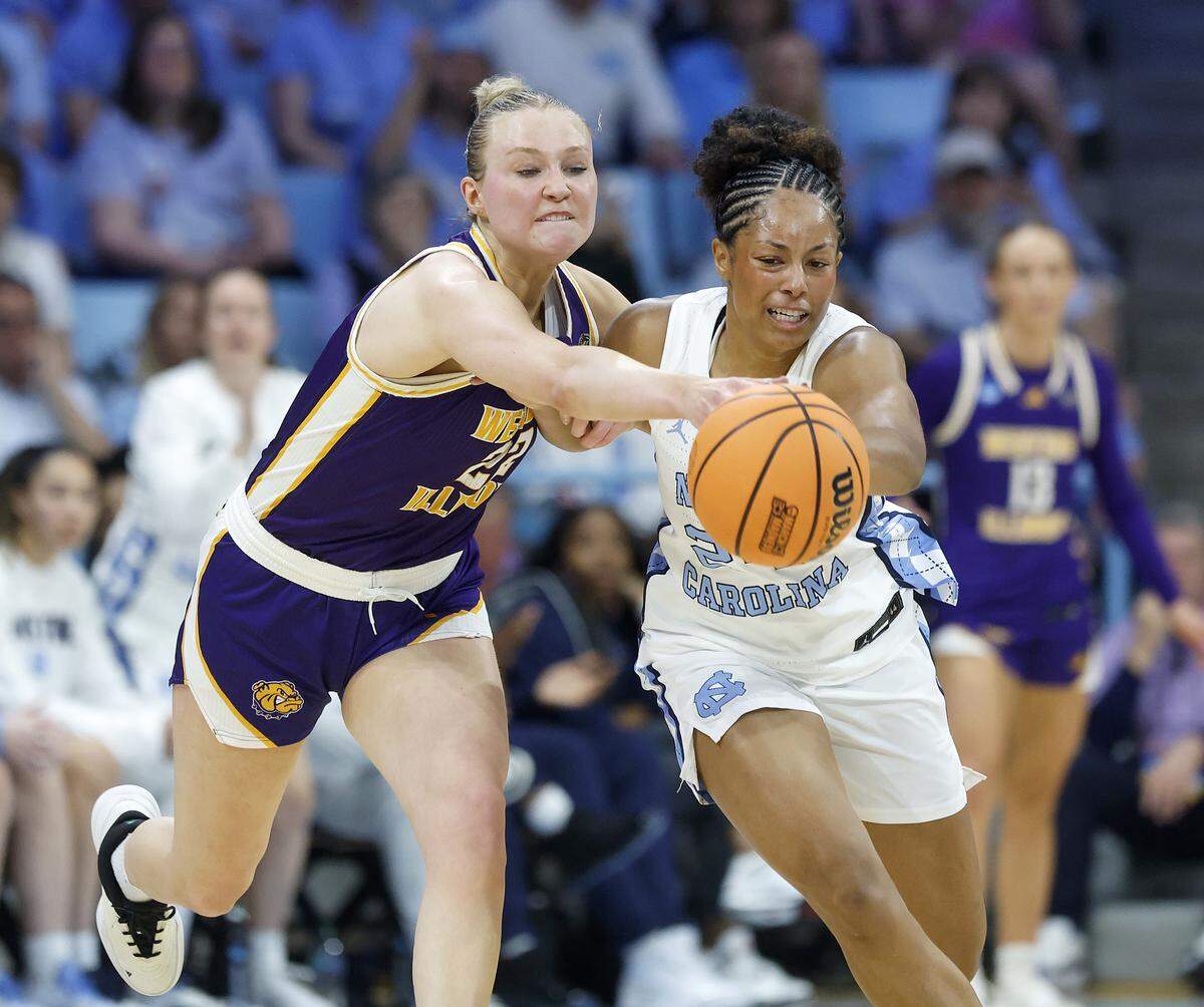 Western Illinois’ Mia Nicastro and North Carolina’s Indya Nivar chase after a loose ball during the first half of the Tar Heels’ first-round NCAA Tournament game on Friday, March 20, 2026, at Carmichael Arena in Chapel Hill, N.C.