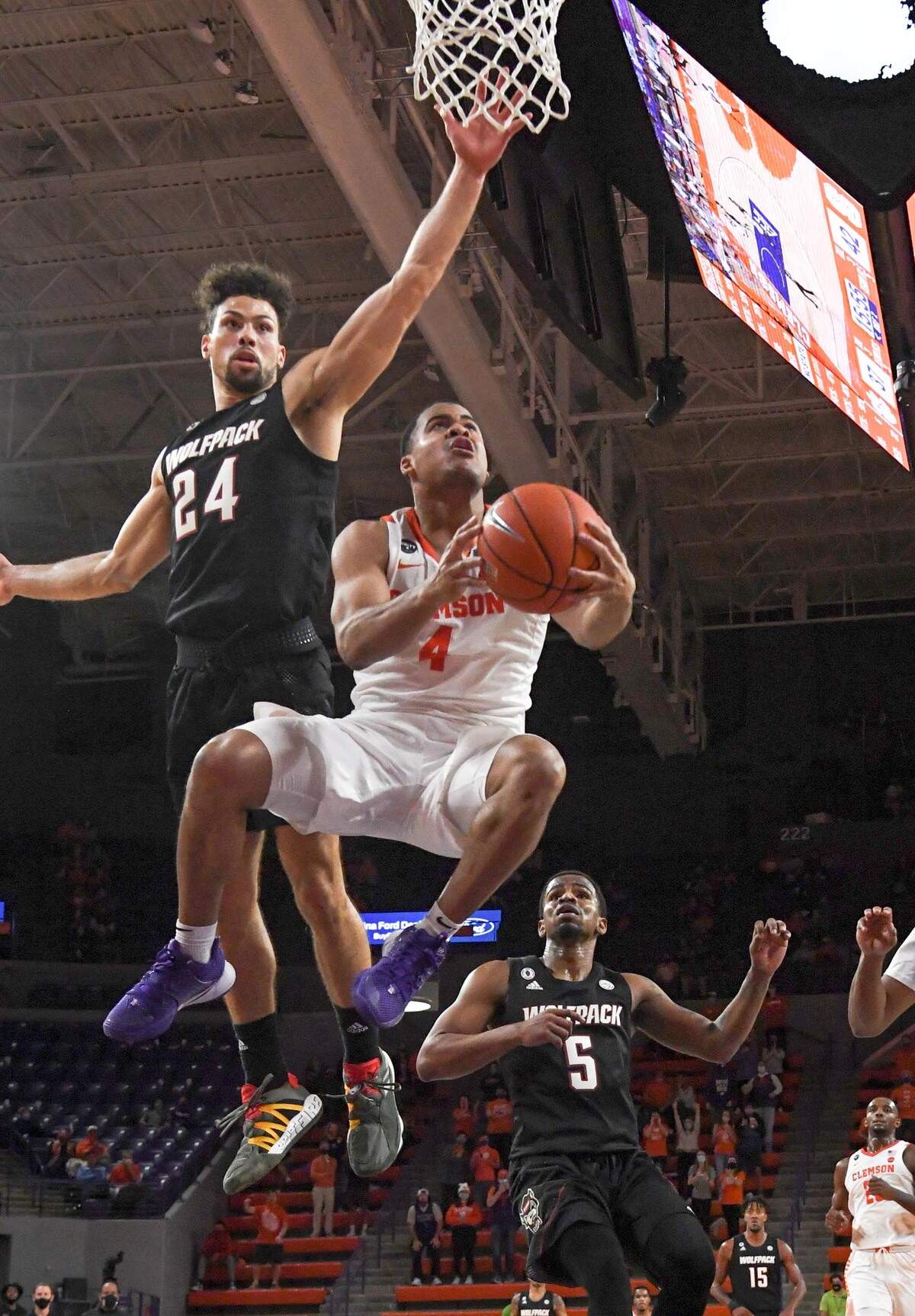 Clemson sophomore guard Nick Honor(4) makes a shot around the defense of NC State guard Devon Daniels(24) Jan 5, 2021.