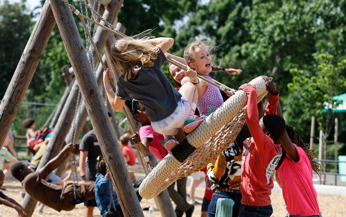 Nova Price, 11, of Raleigh, center, is one of the many enjoying the 91-foot long mega swing at Gipson Play Plaza at Dix Park during a preview day Saturday, May 24, 2025. The park will officially open with a grand opening celebration on June 6th, 7th and 8th.