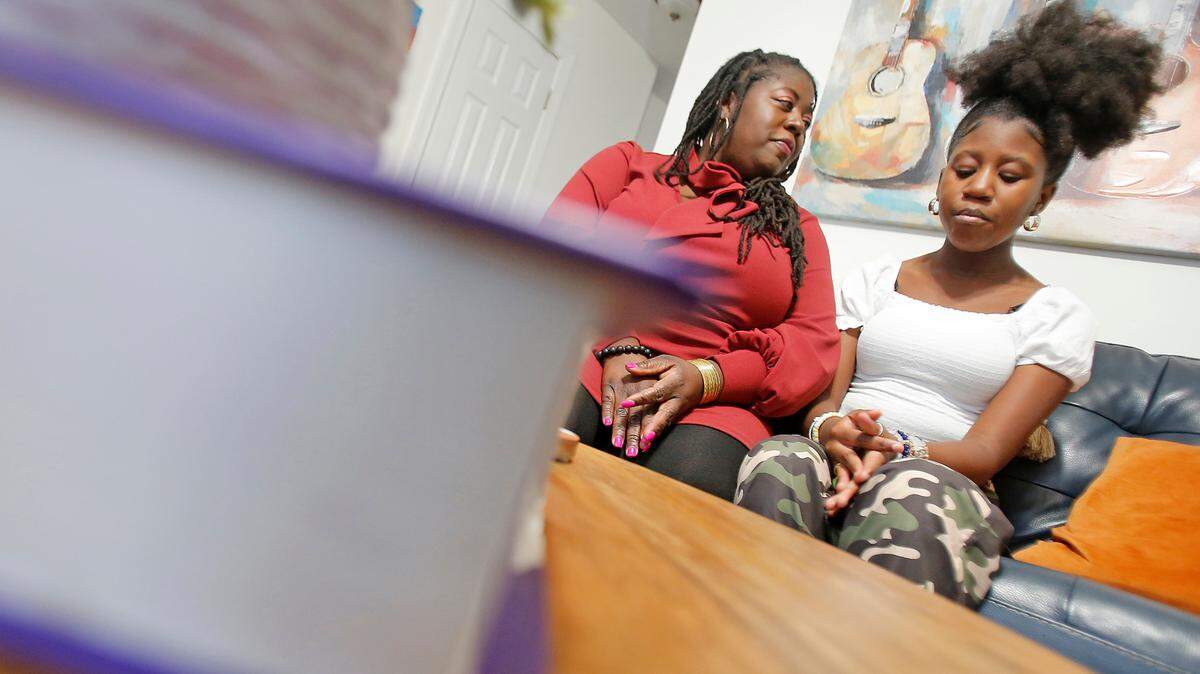 Yolanda Taylor and her 12-year-old daughter Chloe Taylor sit inside their home Wednesday evening in Wake Forest March 8, 2023. Yolanda Taylor is concerned about the efforts to ban books and pass the Parents Bill of Rights Act in North Carolina.