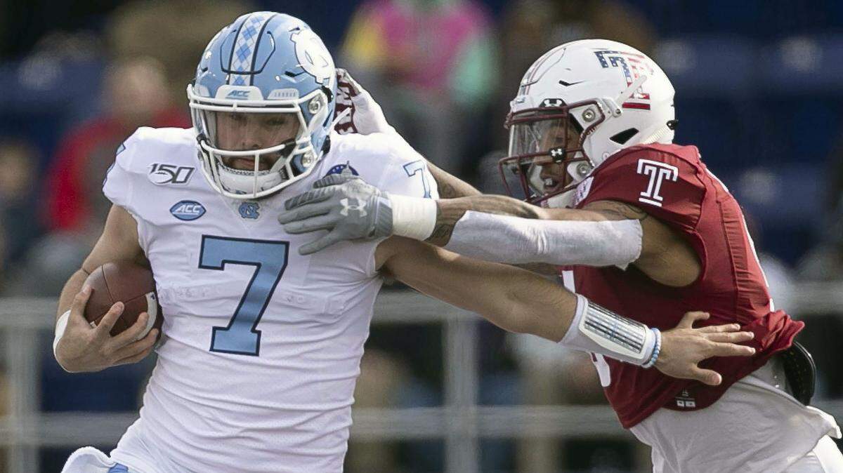 North Carolina quarterback Sam Howell (7) rushes for 24 yards ahead of Temple’s Shaun Bradley (5) in the first quarter during the Military Bowl on Friday, December 27, 2019 at Navy-Marine Corps Memorial Stadium in Annapolis, Maryland. The attempt failed.