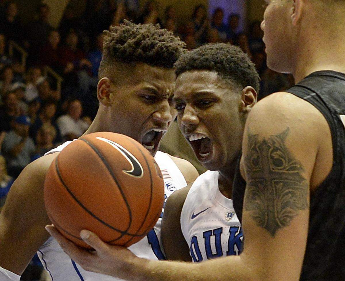 Duke forward Javin DeLaurier (12) (left) and   forward R.J. Barrett (5) react after Barrett scored and was fouled in the second half against Army . Duke defeated Army 94-72 at Cameron Indoor Stadium In Durham, N.C. Sunday, Nov. 11, 2018.