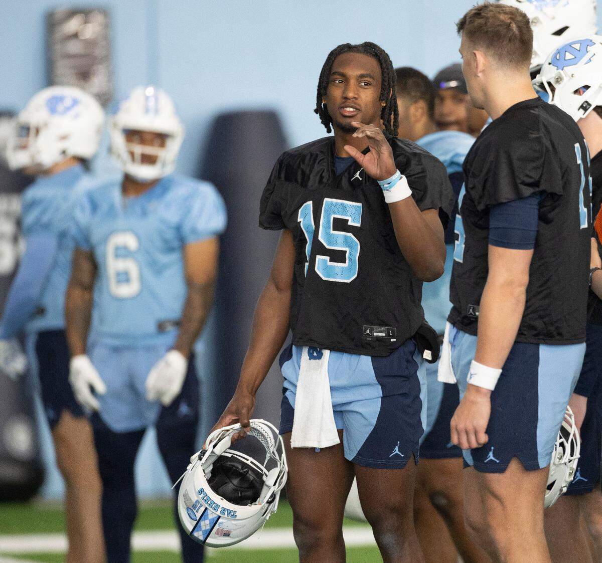 North Carolina sophomore quarterback Conner Harrell (15) talks with graduate transfer quarterback Max Johnson (14) during the Tar Heels’ opening day of spring football practice on Tuesday, March 19, 2024 in Chapel Hill, N.C.