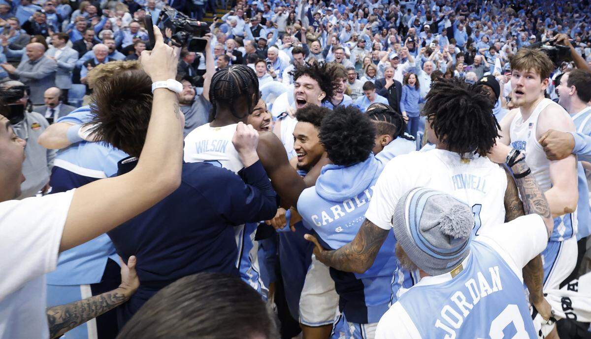North Carolina's Seth Trimble is mobbed by teammates after hitting the game winning three-pointer during  UNC’s 71-68 victory over Duke at the Dean E. Smith Center in Chapel Hill, N.C., Saturday, Feb. 7, 2026.