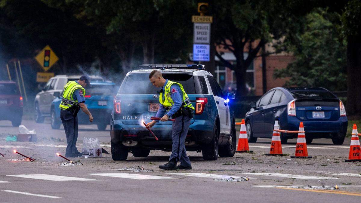 Raleigh Police officers keep traffic flowing at the intersection of Six Forks and Lassiter Mill Roads in Raleigh where traffic lights were out Saturday morning, Oct. 1, 2022 after the remnants of Hurricane Ian left thousands without power in Triangle.