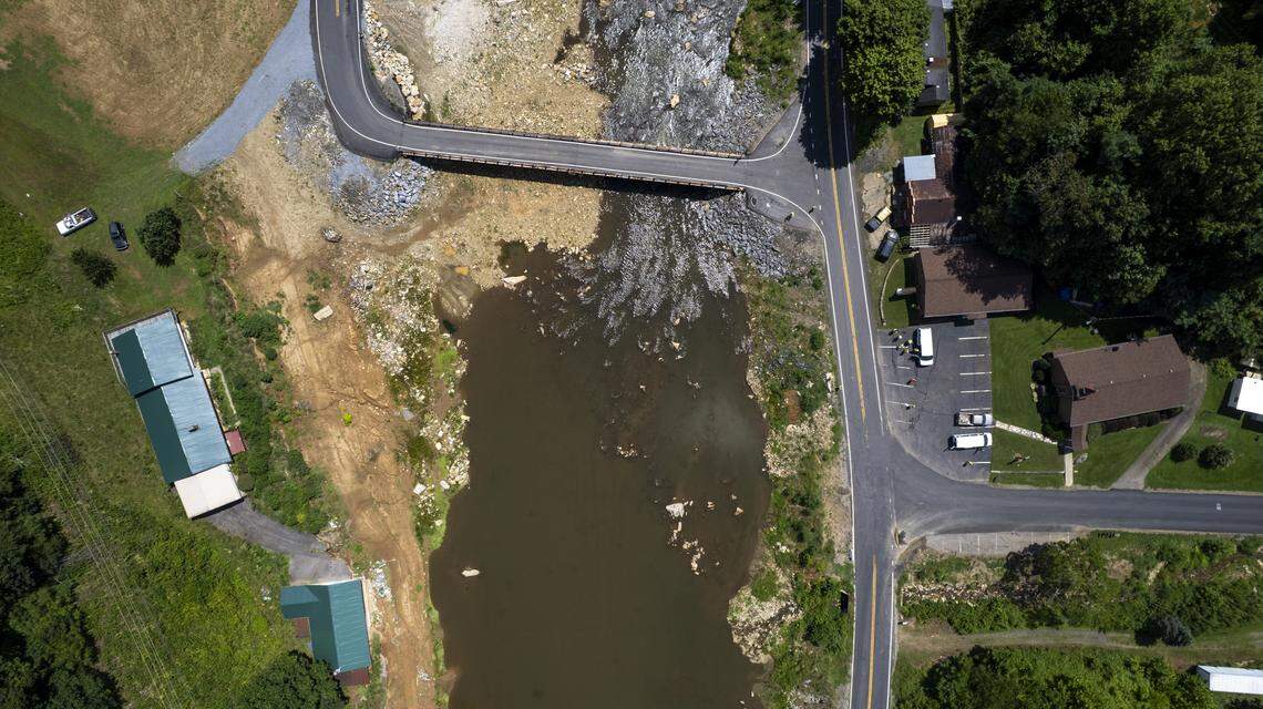 An aerial view of a temporary bridge carrying Will Higgins Road over the Cane River, at the intersection with U.S. 19W in Yancey County in August. Flooding from the remnants of Hurricane Helene washed away the bridge and much of the road in 2024. The temporary bridge, made of railroad flat cars, will need to be replaced.