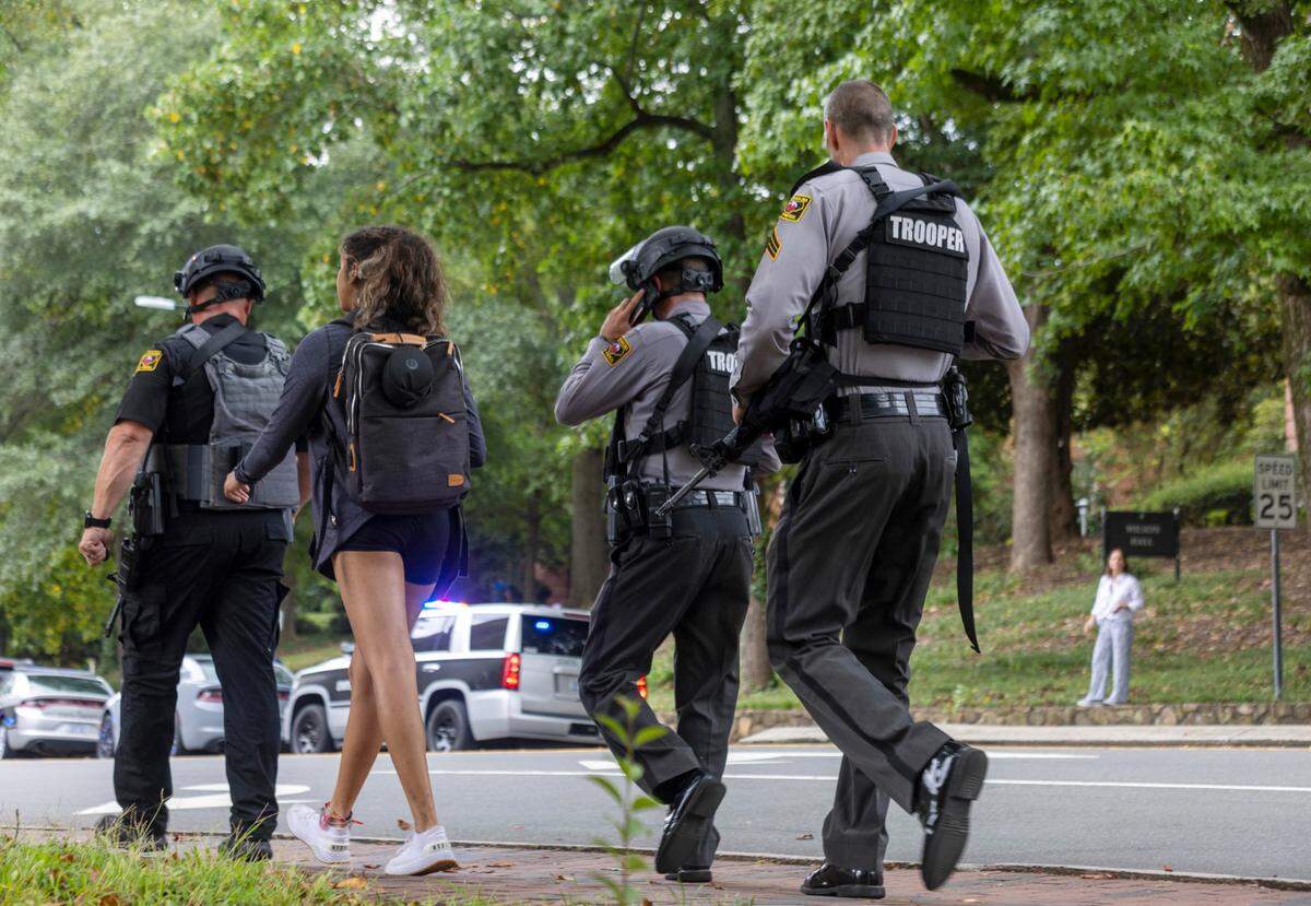 North Carolina State Troopers walk down South Road toward the Bell Tower on the UNC-Chapel Hill campus in August 2023. Proposed changes in retirement benefits could affect local and state officers.