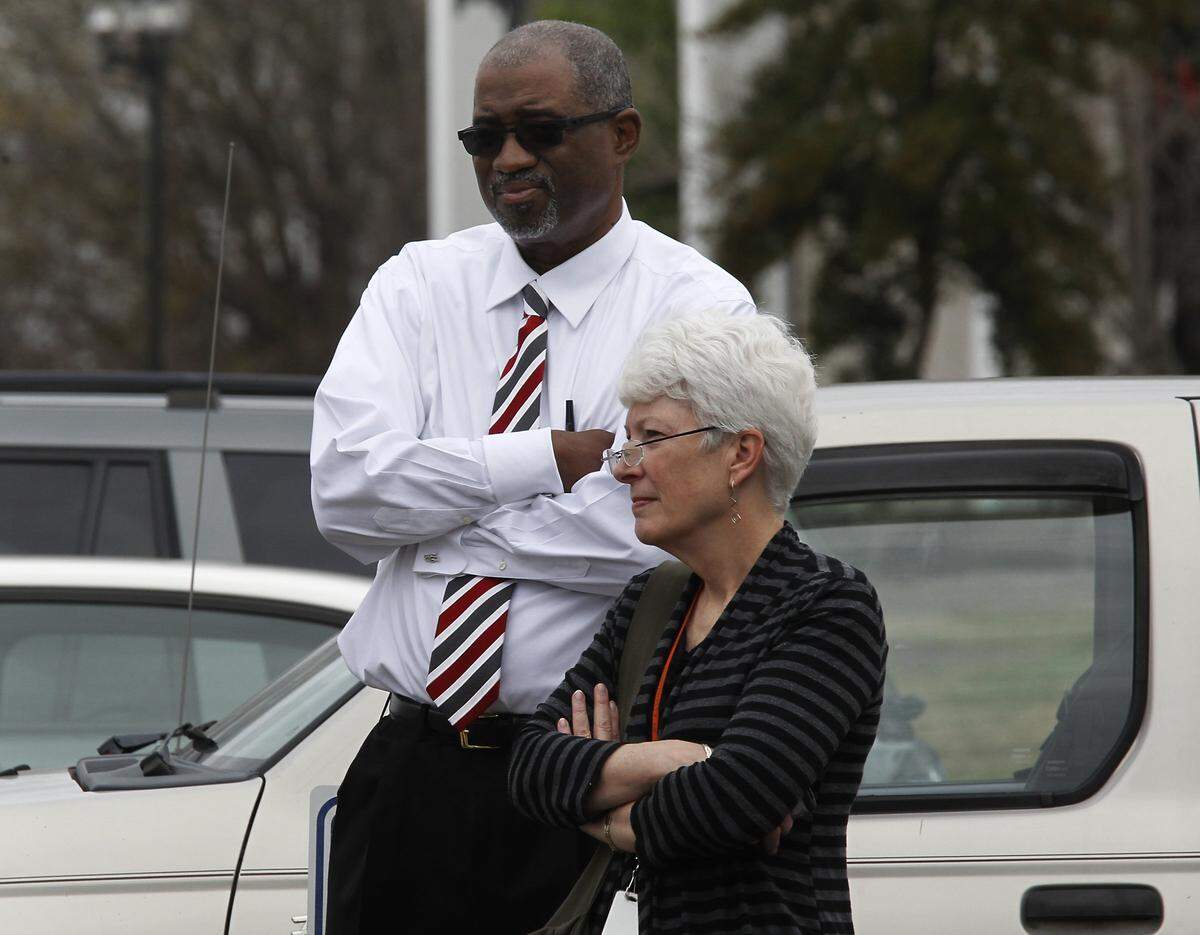 Judge Orlando Hudson and Durham trial court administrator Kathy Shuart stand across the street from the Durham County Courthouse during an evacuation of the building. Hudson was hearing the opening statement of David Rudolf in the Mike Peterson hearing when the building was evacuated. The hearing is in recess until 2:30 for lunch.