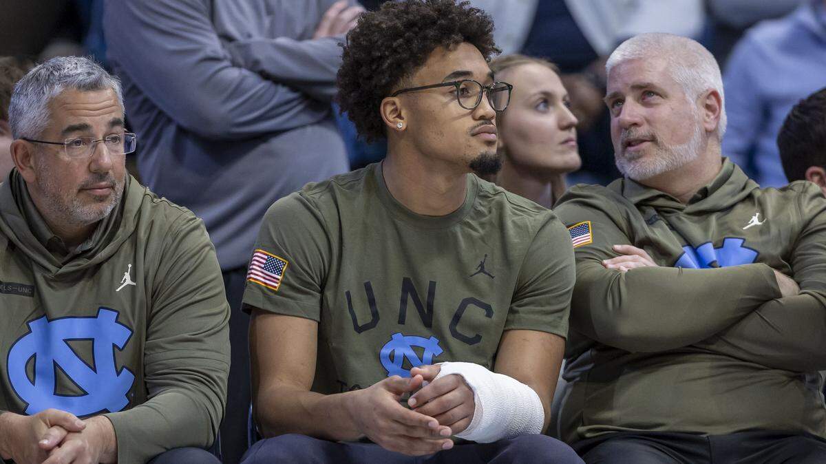 North Carolina guard Seth Trimble (7) takes a place at the end of the bench as he recovers from an injury, during the Tar Heels’ game against Radford on Tuesday, November 11, 2025 at the Smith Center in Chapel Hill, N.C. Trimble will not play for several weeks after breaking a bone in his left arm.
