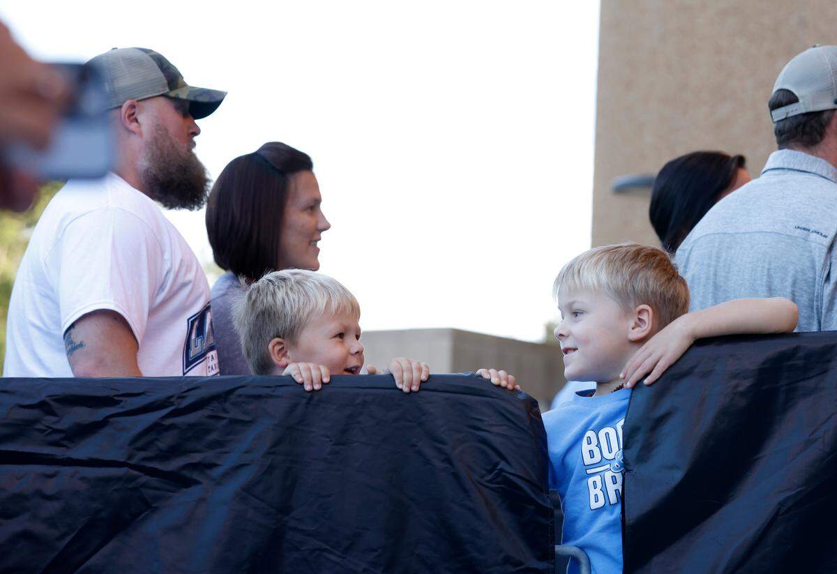 Brothers Cash Lindsay, 3, and Tripp Lindsay, 4, smile as they wait to be admitted to the Dean E. Smith Center prior to “Live Action with Carolina Basketball” on Friday, Oct. 7, 2022, in Chapel Hill, N.C.