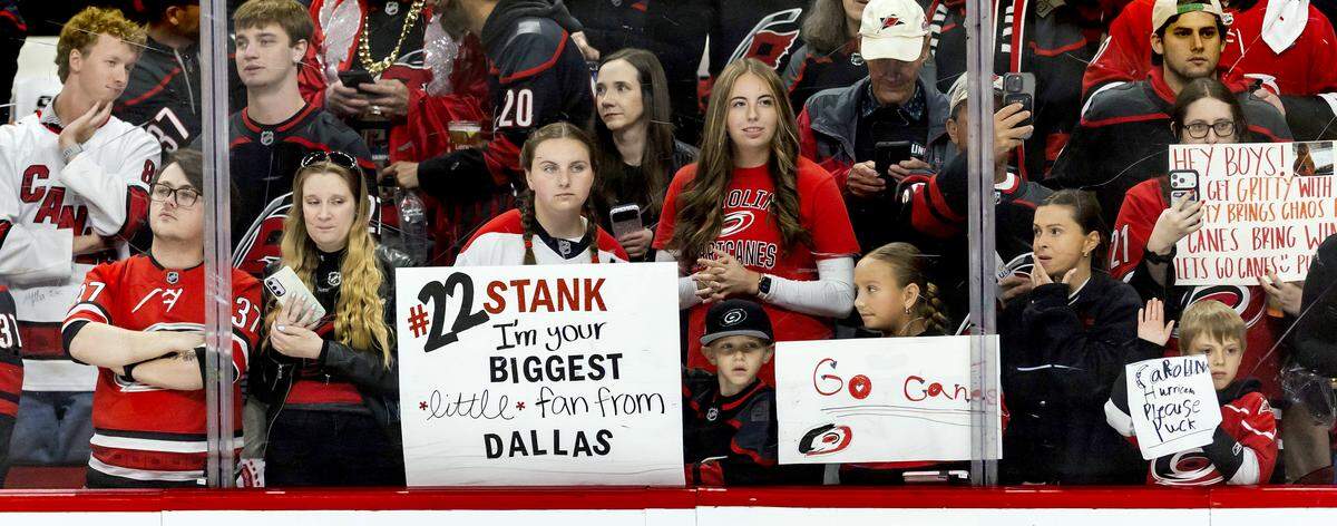 Carolina Hurricanes fans line up against the glass during pre-game warm ups ahead of Game 1 against Philadelphia on Saturday, May 2, 2026, during the second round of the Stanley Cup Playoffs at Lenovo Center in Raleigh, N.C.