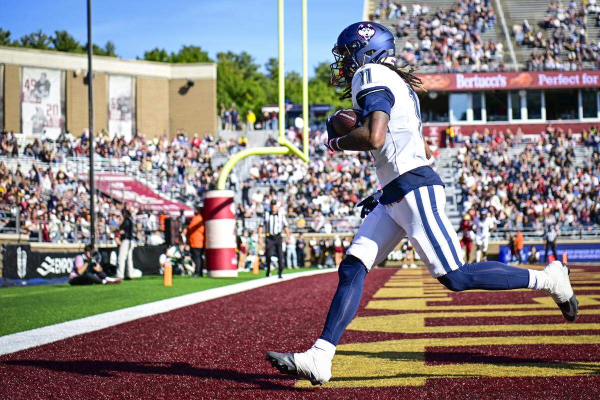 Juice Vereen of the UConn Huskies scores a touchdown during a game against the Boston College Eagles at Alumni Stadium on October 18, 2025 in Chestnut Hill, Massachusetts. 
