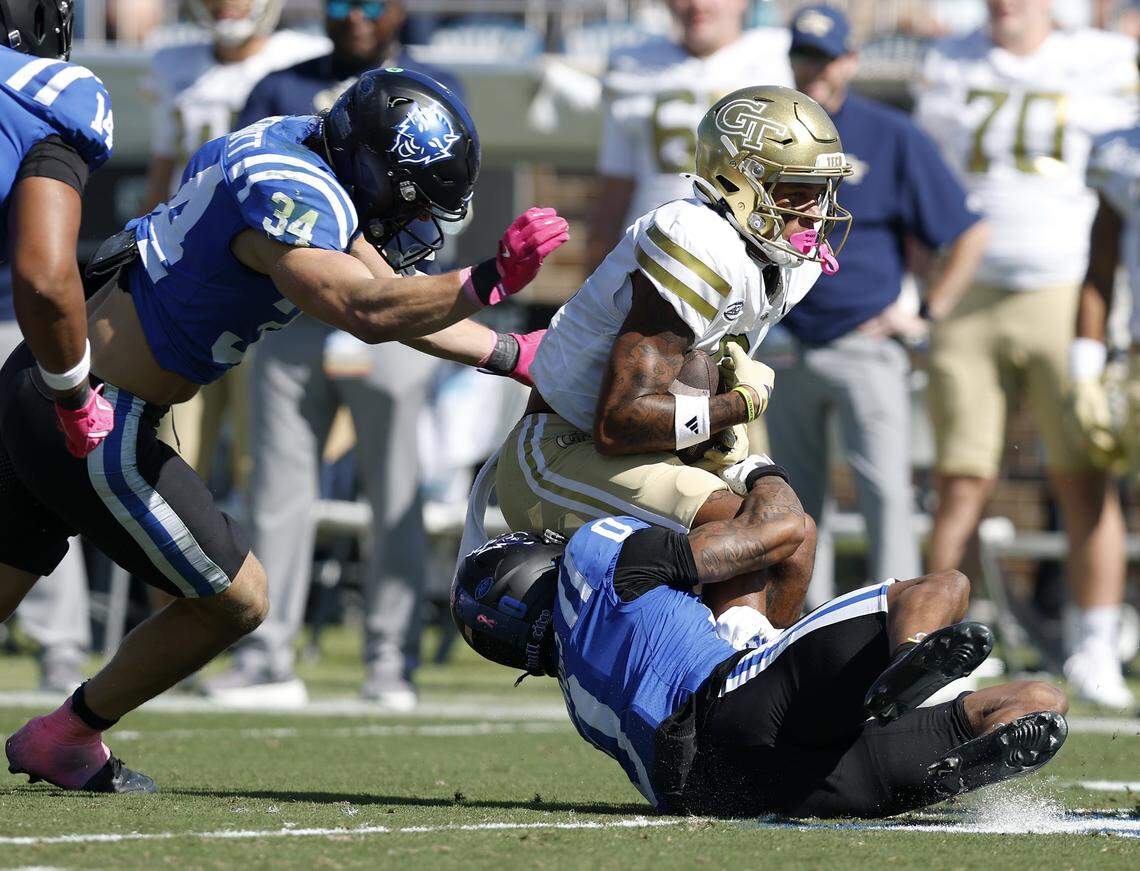 Duke’s Luke Mergott and Chandler Rivers bring down Georgia Tech’s Eric Rivers during the first half of the Blue Devils’ game on Saturday, Oct. 18, 2025, at Wallace Wade Stadium in Durham, N.C.