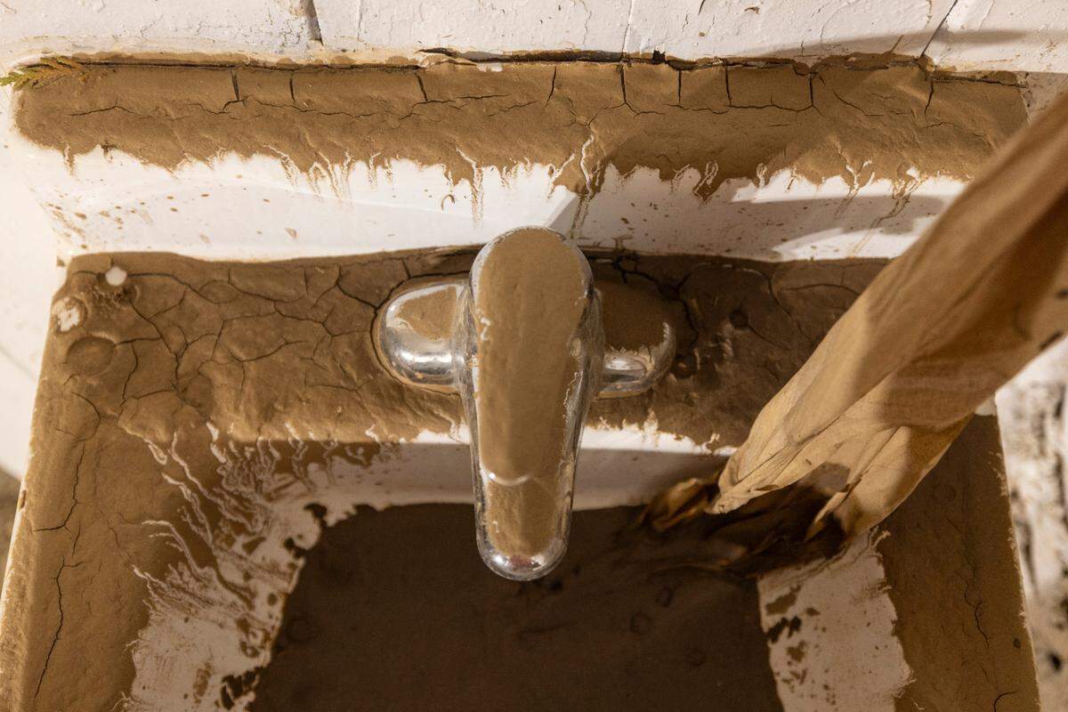 A mud covered sink in Pisgah Memorial Stadium on Friday, October 18, 2024 in Canton, N.C. The stadium has been closed since Hurricane Helene pushed the Pigeon River into the stadium, with water levels reaching the cross-bars on each goal post.