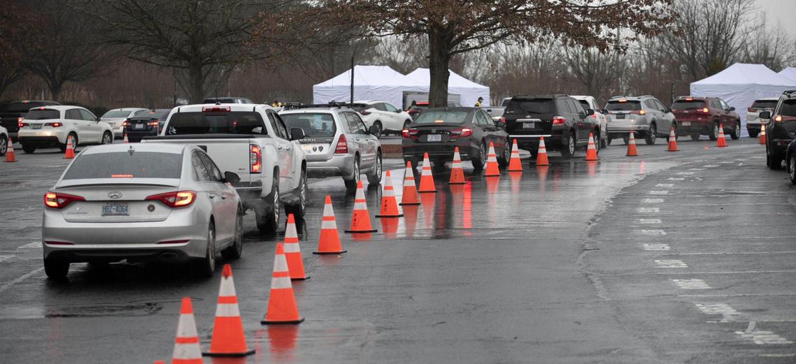 Patients line up their cars to receive the COVID-19 vaccine during a Wake County mass vaccination clinic on Thursday, February 11, 2021 at PNC Arena in Raleigh, N.C.