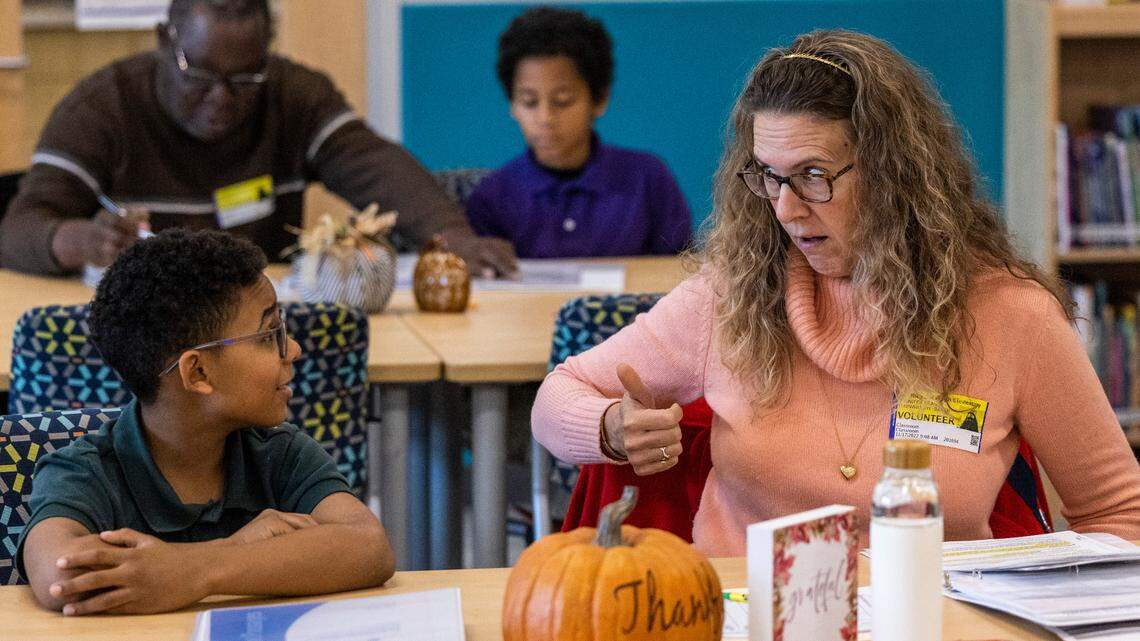 Volunteer tutor Gigi Waynewright-Baker and Nathaniel Grant, 10, take part in the new WakeTogether tutoring program on Nov. 17, 2022 at Southeast Raleigh Elementary School. A proposed school district policy update would allow teachers to be paid by parents to tutor students as long as the child is not in their class.