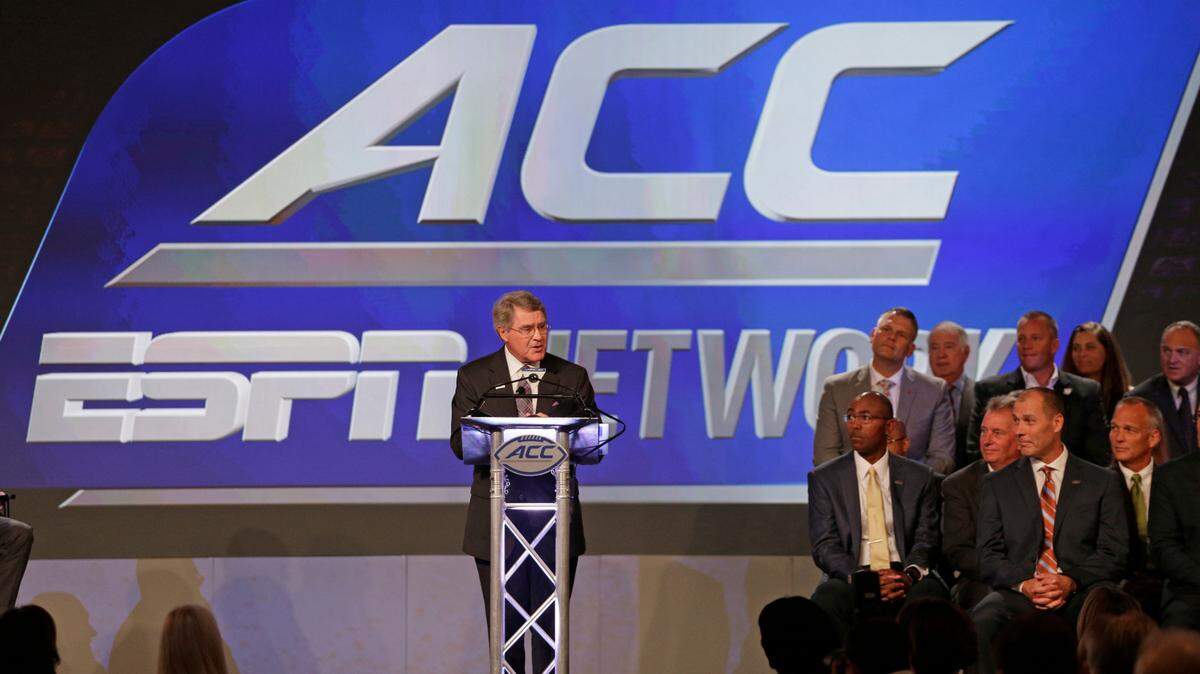 In this 2016 file photo, ACC Commissioner John Swofford, center, announces an ACC/ESPN Network during a news conference at the Atlantic Coast Conference Football Kickoff in Charlotte,