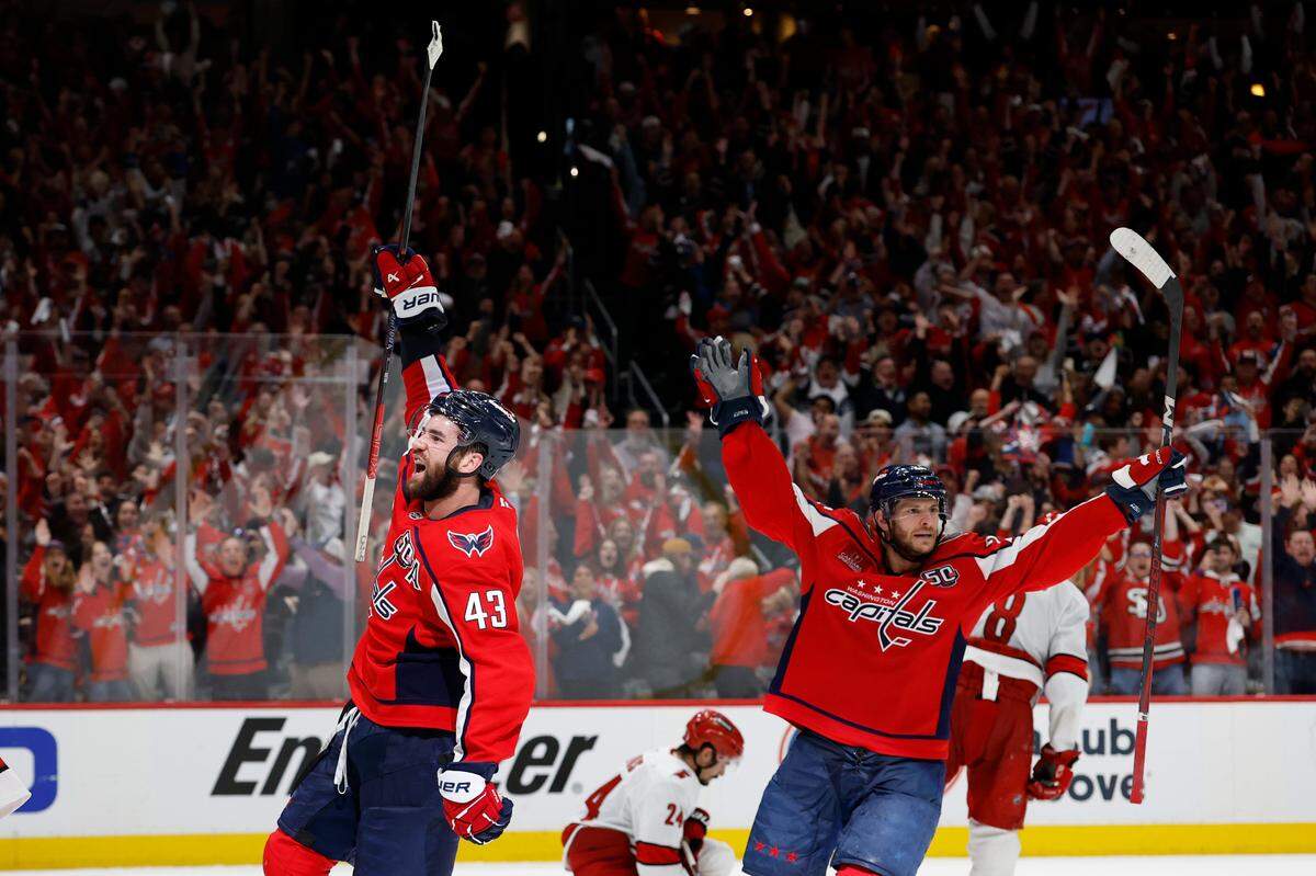 May 8, 2025; Washington, District of Columbia, USA; Washington Capitals right wing Tom Wilson (43) celebrates with Capitals center Nic Dowd (26) after scoring an empty net goal against the Carolina Hurricanes in the third period in game two of the second round of the 2025 Stanley Cup Playoffs at Capital One Arena. Mandatory Credit: Geoff Burke-Imagn Images